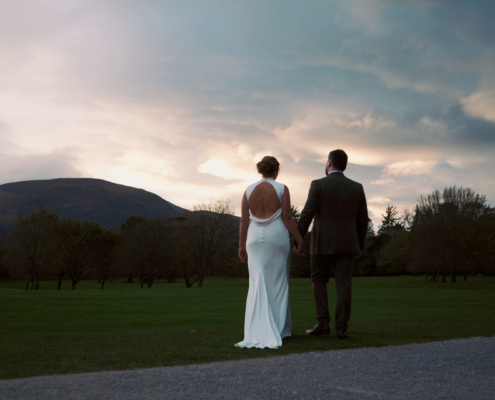 Ellen and Cian smiling together outside the Great Southern Hotel Killarney during their wedding day, captured in a cinematic Irish wedding film