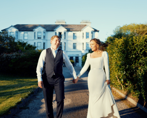 Elegant wedding couple at Gougane Barra chapel by the lake in Cork, cinematic Irish wedding film still